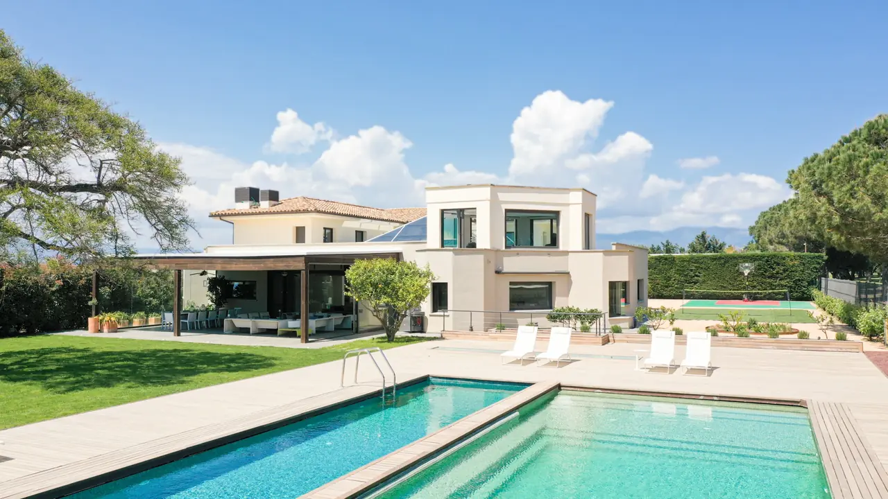 Pool with villa and mountain backdrop